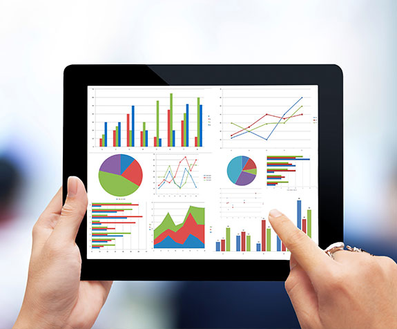 Employee holding an iPad and generating charts